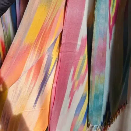 Hanging Lomyna Lala Wrap towels displayed in multiple color variations.
