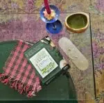 Folded Lomyna LOSA towel placed on a living room table next to magazines, with a rug visible under the table.