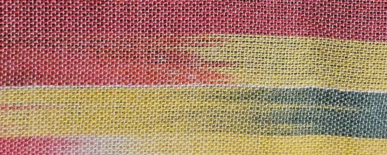 “Close-up texture of the Lala lightweight cotton travel wrap, showing its soft weave and breathable cotton fibers.”