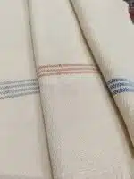 Close-up of LOCO cotton towel with a simple cotton background and a few short stripes